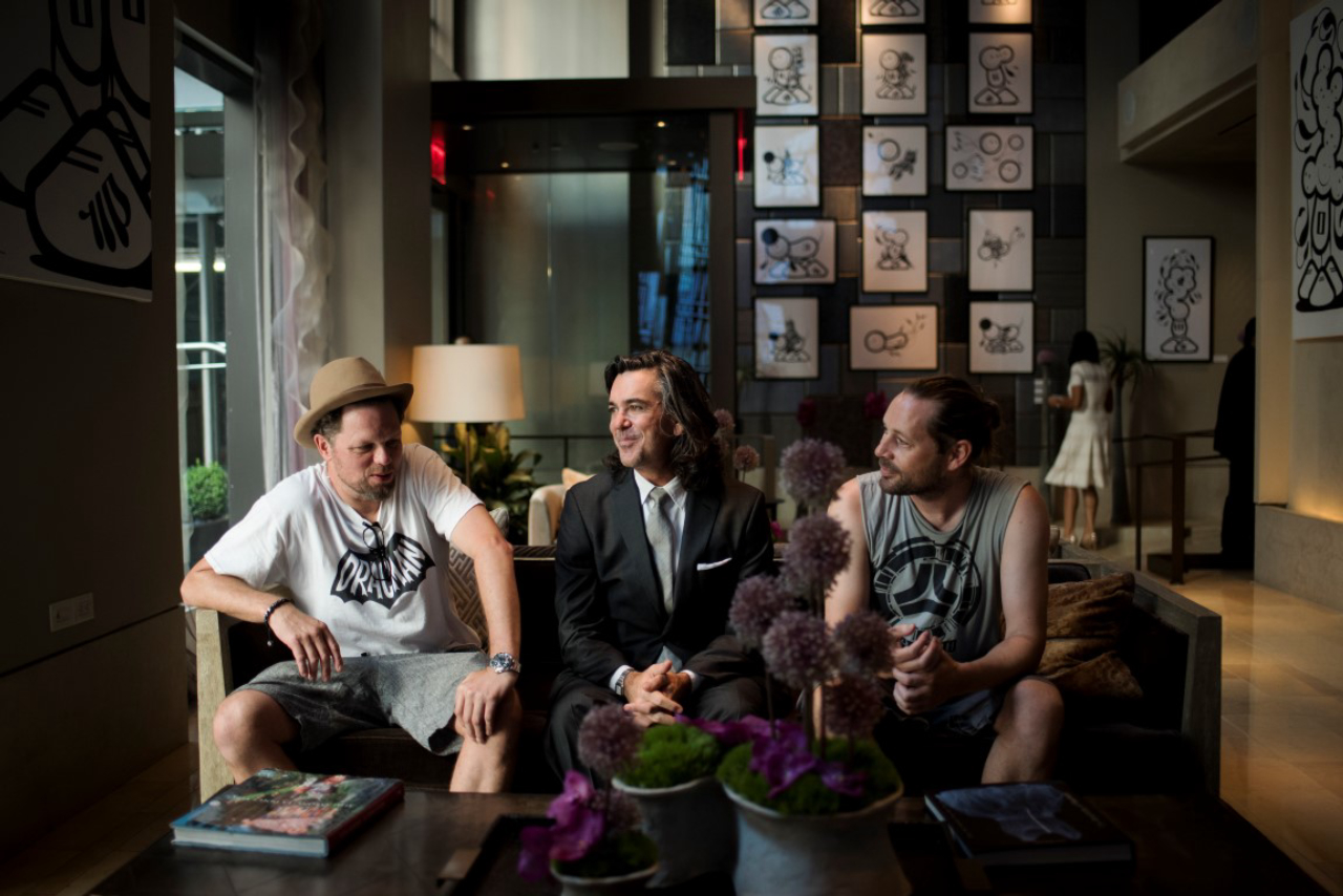 From left: former resident artist Nick Walker, the Quin Hotel’s art curator, with DK Johnston and Chaz Barrisson of the street art duo London Police in the hotel’s lobby, in New York, Aug. 18, 2016. As hotels aim to distinguish themselves in the Airbnb era, many see artist-in-residence programs as a way to add allure. (Hilary Swift/The New York Times)