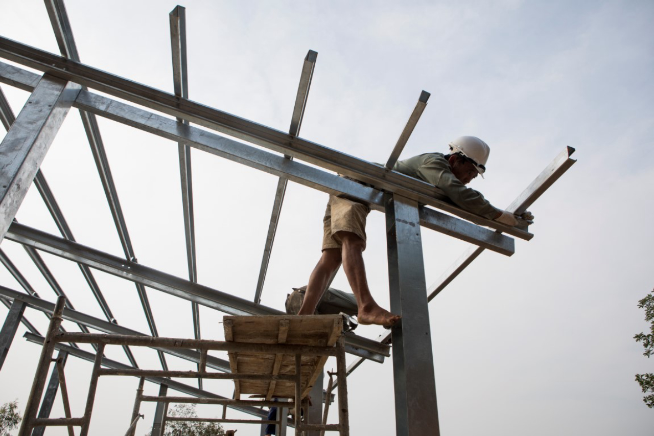 Builders construct the frame of an “S House,” designed by architect Vo Trong Nghia, in Hanoi, Vietnam, on April 20, 2017. Nghia plans to mass-manufacture the easy-to-assemble design for people in slums, remote areas or refugee camps around the world for the starting price of $1,500. (Amanda Mustard/The New York Times)
