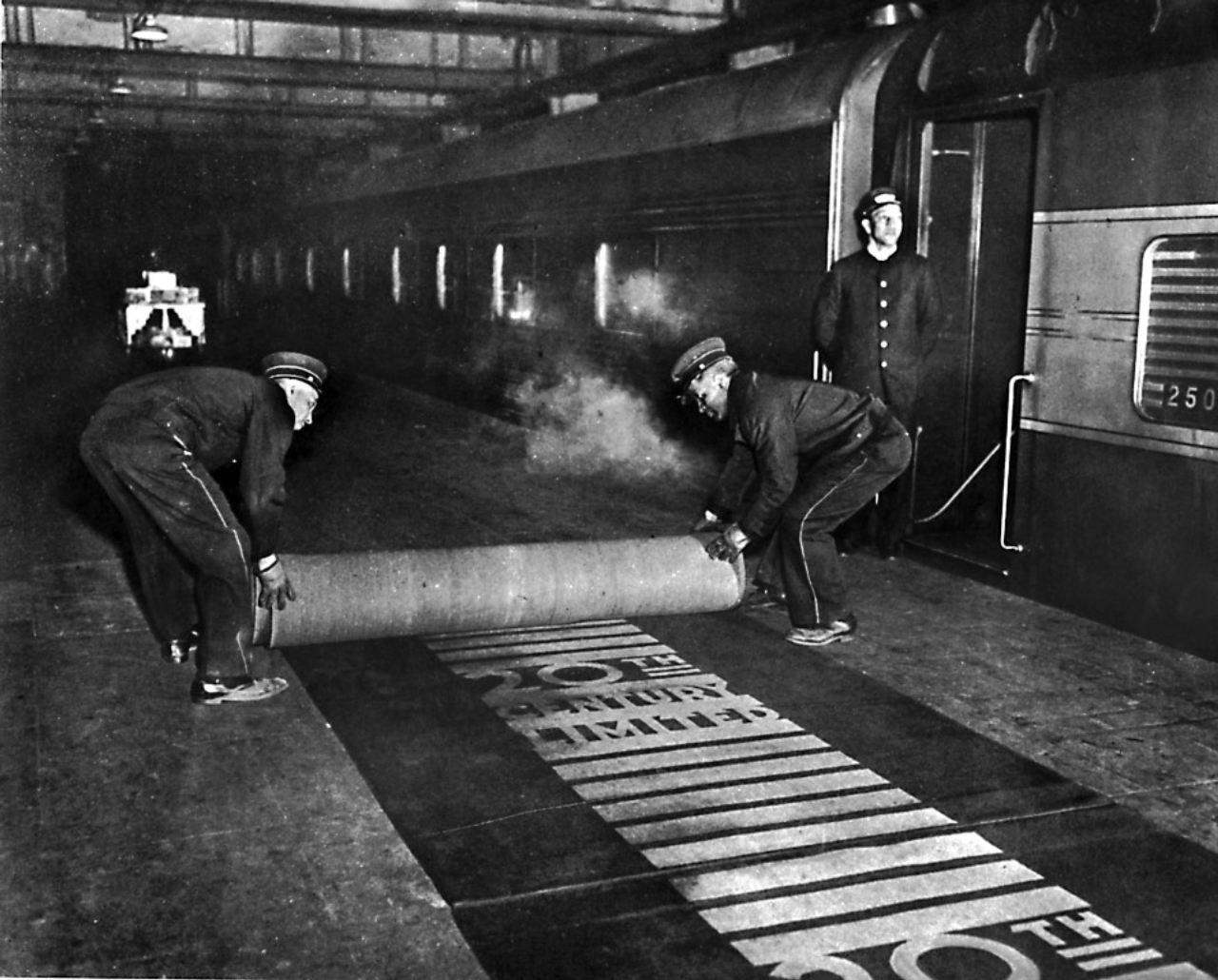 In an undated photo, workers rolling out the red carpet for passengers of the Twentieth Century Limited at Grand Central Terminal in New York. Amtrak will temporarily restore some intercity service to Grand Central Terminal to relieve pressure on the beleaguered Pennsylvania Station. (The New York Times)