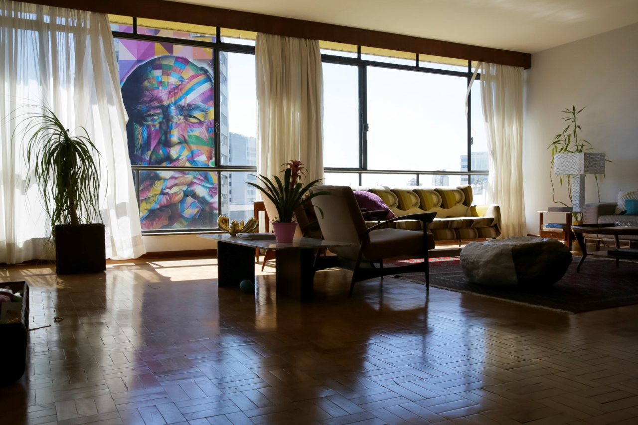 Mural do artista Kobra retratando Oscar Niemeyer fica em destaque da janela do apartamento dos anos 1960. 