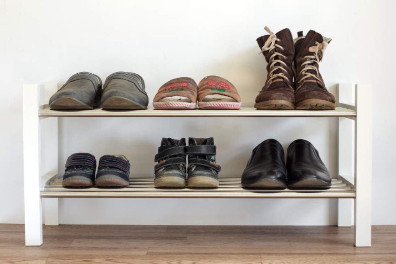 Six pairs of shoes on a shelf in the hallway in the house for the whole family: dad's mama's and child.