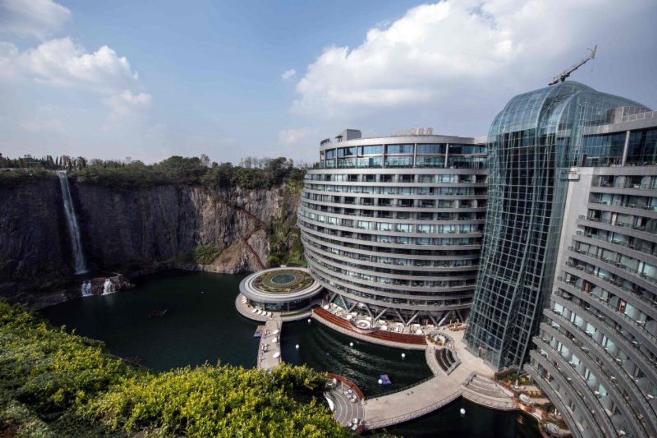 TOPSHOT - This picture taken on November 13, 2018 shows the InterContinental Shanghai Wonderland, built inside a formerly abandoned quarry, about 32 kms (20 miles) southwest of Shanghai. - Engineers faced unique challenges and guests will need deep pockets, but the hotel built into a disused Shanghai quarry opened on November 15 as part of a 288 million USD development. (Photo by Johannes EISELE / AFP)