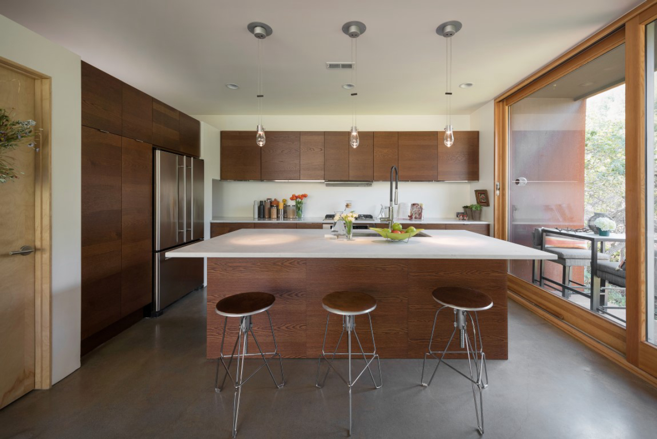 Expect to see more kitchens completely open to decks and patios via collapsible doors and window walls in the coming months. MUST CREDIT: Lucy Call/Houzz