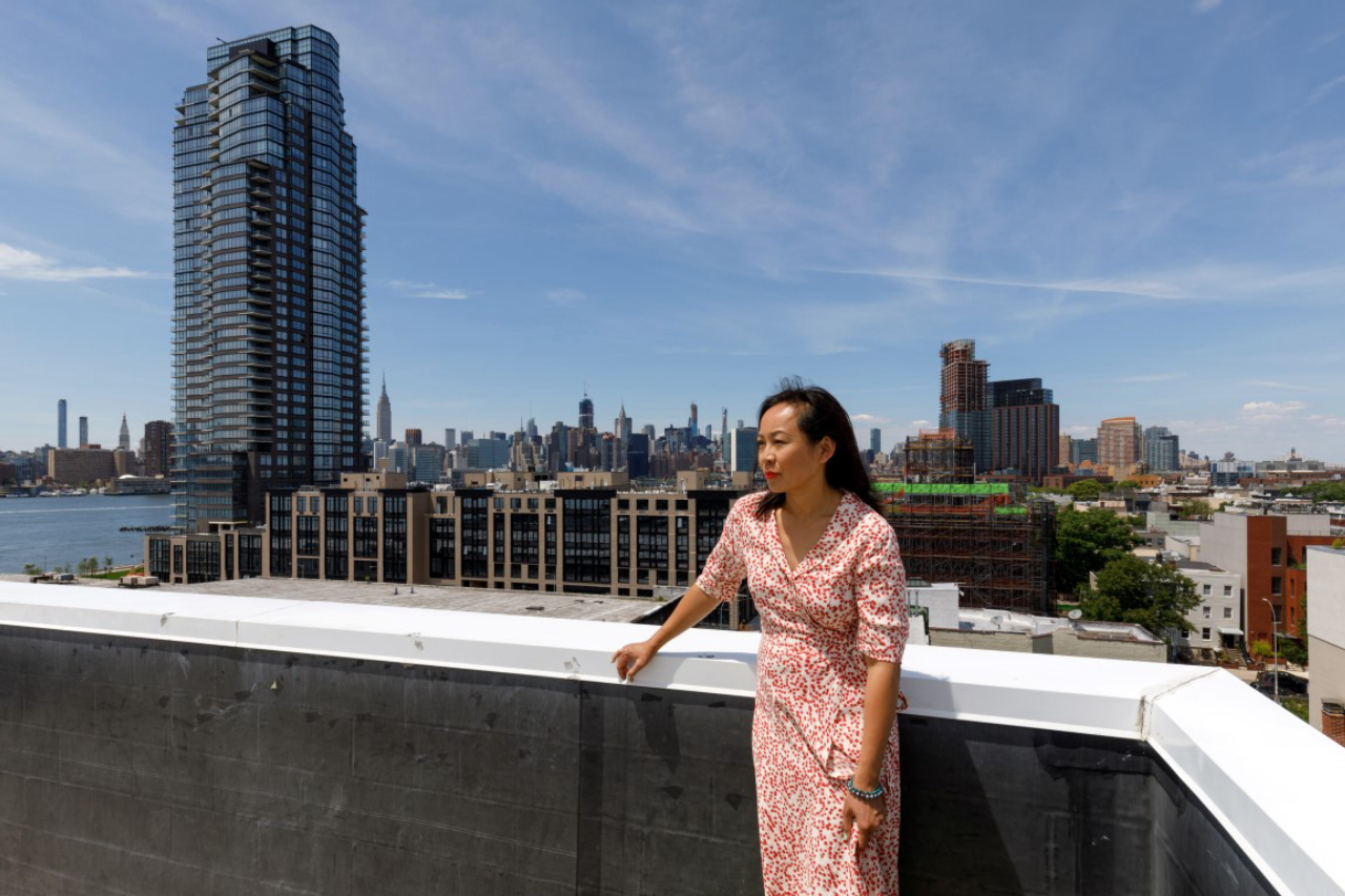 Alyce Chan on the rooftop of her apartment building in the Greenpoint section of Brooklyn on June 12, 2019. Chan bought a two-bedroom unit four years ago, but says her growing family can't afford to stay in the area because all the new development has driven prices up.  (Stefano Ukmar/The New York Times)