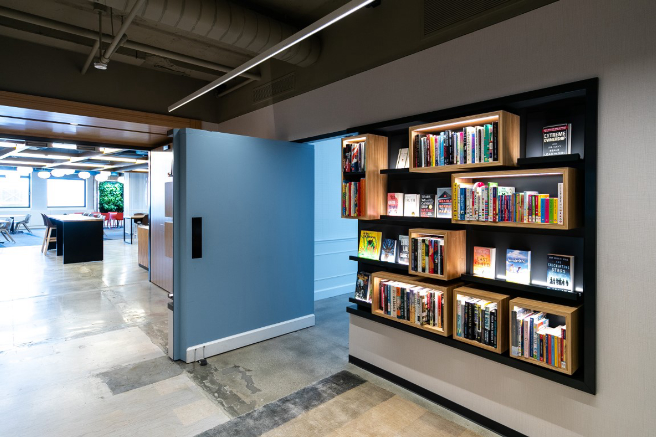 A wall with bookshelves pivots to reveal a secret green room at Macmillan Publishers in New York, Aug. 9, 2019. Secret rooms are popping up in workplaces. (Jeenah Moon/The New York Times)