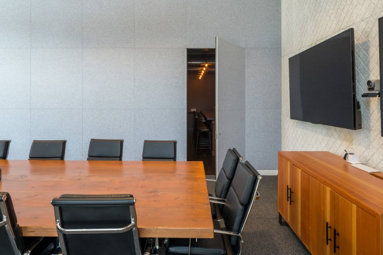 A hidden door in a conference room opens to reveal a speakeasy-style secret room at the advertising agency Deutsch in Los Angeles, Aug. 9, 2019. Secret rooms are popping up in workplaces. (Hunter Kerhart/The New York Times)