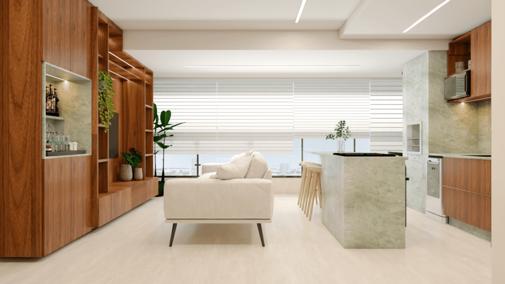 A sala integrada, com o balcão da cozinha em mármore verde, cria uma atmosfera moderna e acolhedora. Projeto: Pêgri Arquitetura.