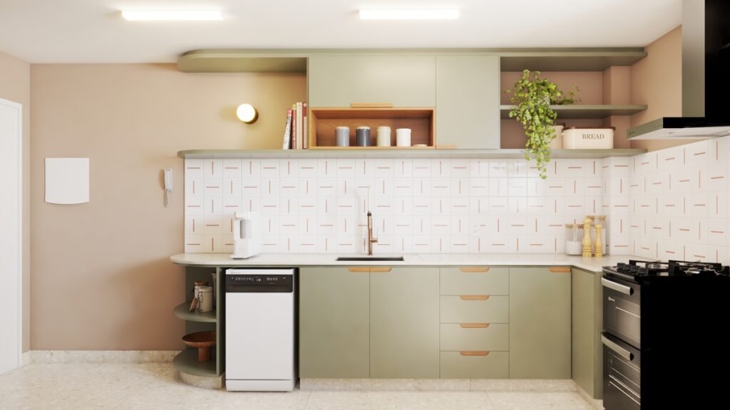 A cozinha ganhou mais espaço de preparo com a bancada estendida e armários verde-sálvia, valorizando o ato de cozinhar a dois. Projeto: Audaz Estúdio.