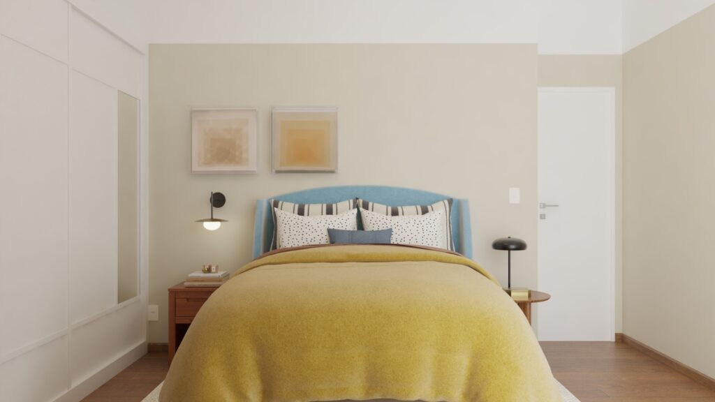 A suíte do casal busca ser um local de descanso, com paredes no tom amarelo trigo para trazer serenidade e mesas de cabeceira assimétricas. Projeto: Audaz Estúdio.