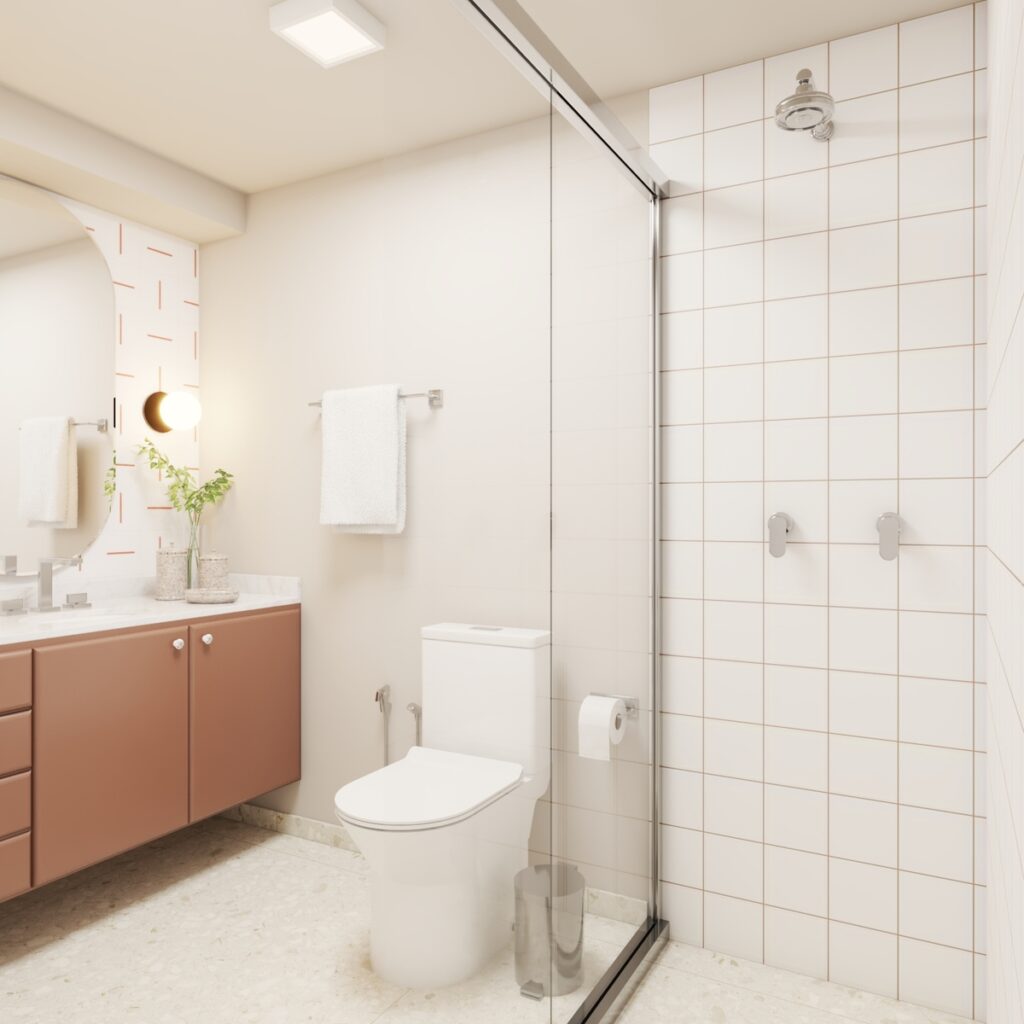 O banheiro social se tornou mais agradável para visitas com a reforma do armário existente e o uso de rejunte terracota no box. Projeto: Audaz Estúdio.