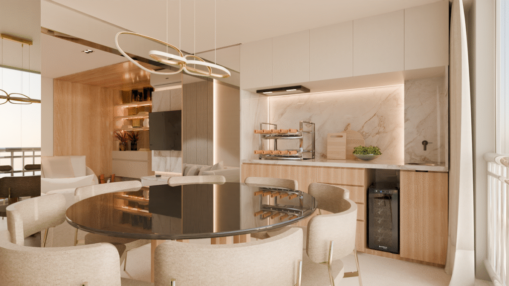 A sala de jantar integrada à cozinha e área de serviço, com bancada em mármore e marcenaria funcional. Projeto: MM Arquitetura.