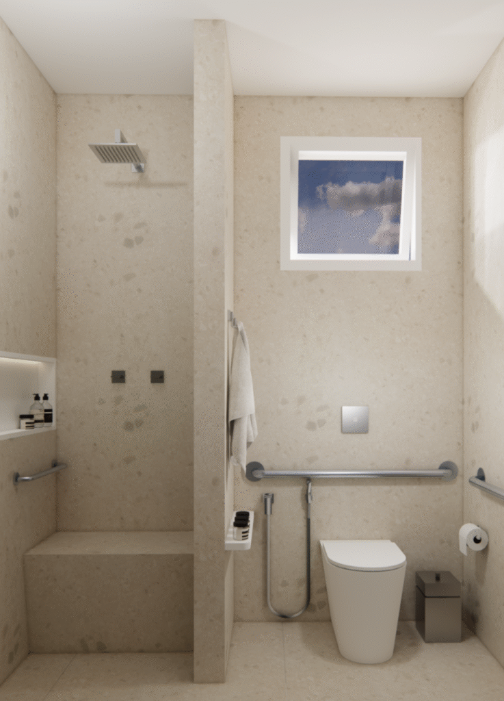 Banheiro com revestimentos neutros e suporte para moradora circular melhor pelo espaço. Projeto: Sávio Rangel Nogueira.