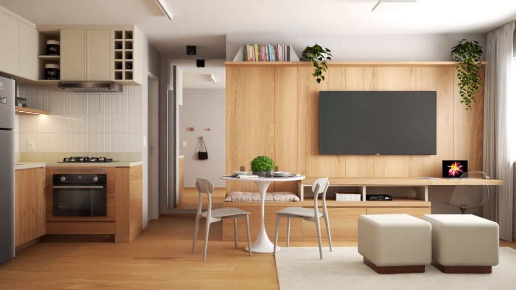 A marcenaria multifuncional é o destaque, integrando as áreas de convivência e criando um nicho de home office discreto. Projeto: Isabela Cardoso Arquitetura.