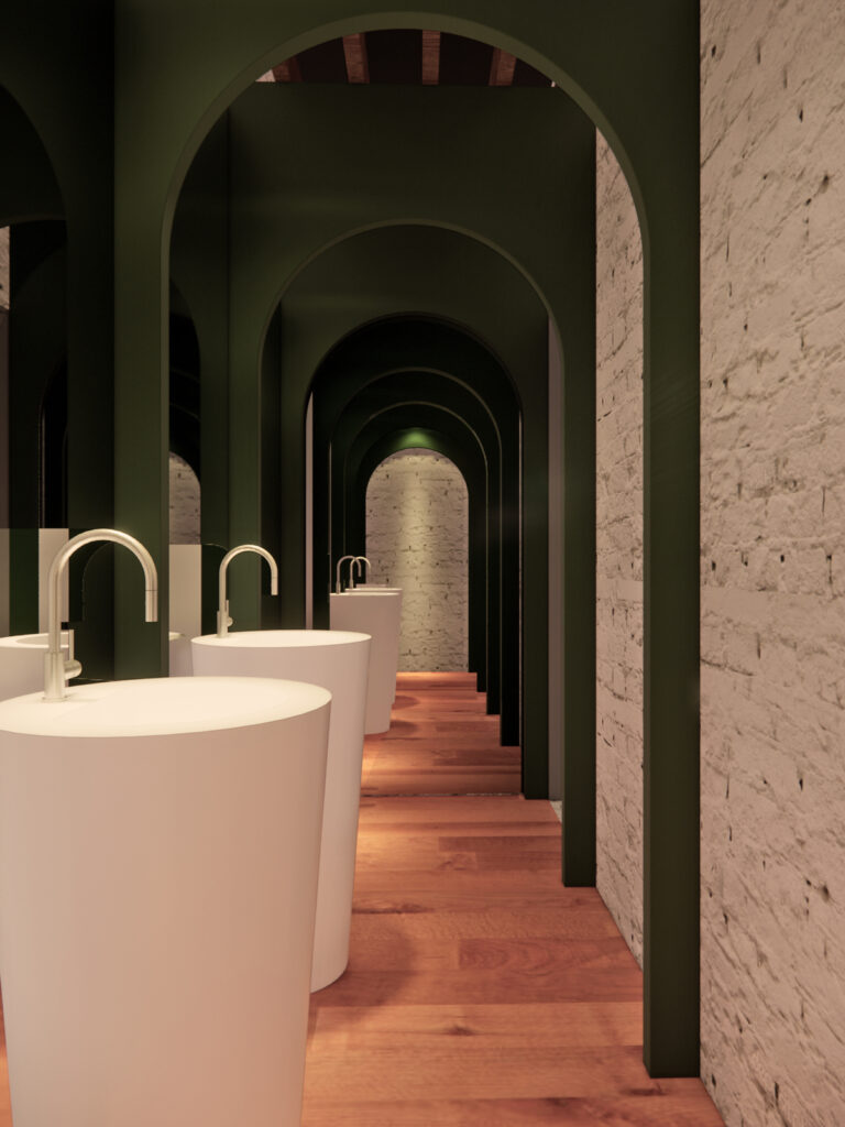 O corredor de lavatórios usa a repetição de arcos para criar uma perspectiva dramática e Instagramável. Projeto: Ultra Arquitetura.